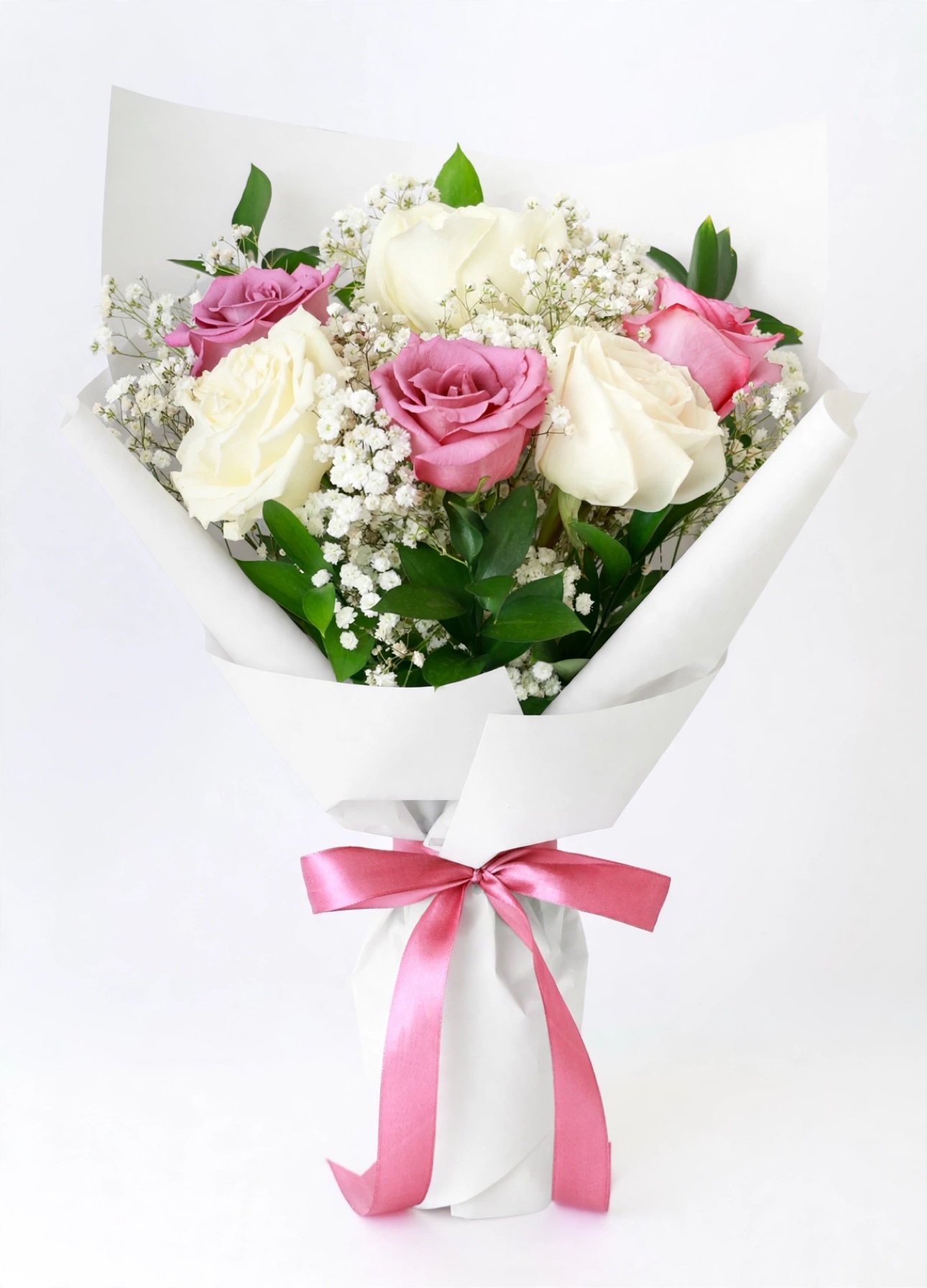 Sweetheart Six — six roses in cream and amethyst with baby's breath in white wrap, tied with a pink satin bow