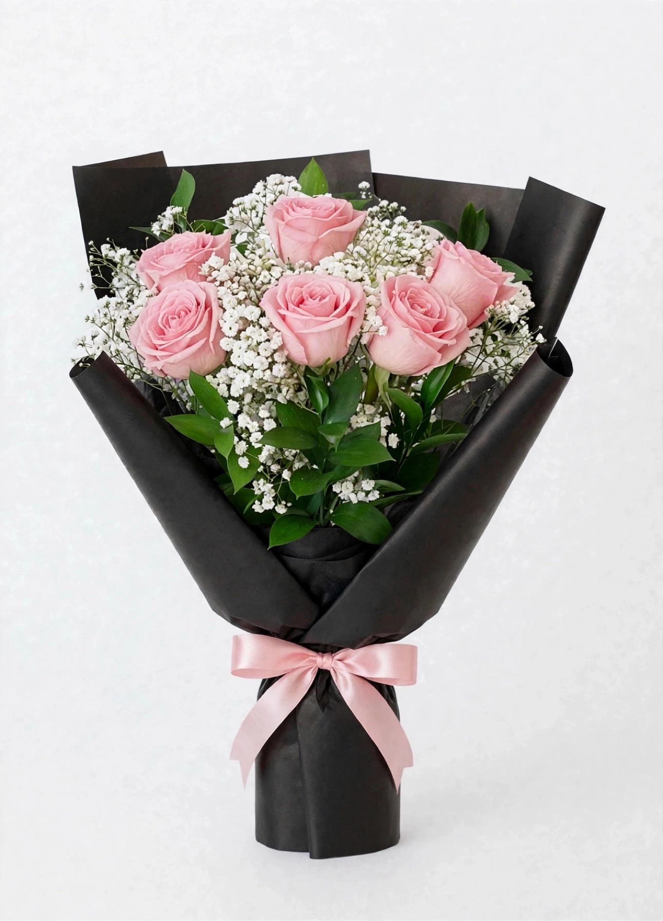 Blush Noir Bouquet — six pink roses with baby's breath in black wrap, tied with a soft pink satin bow